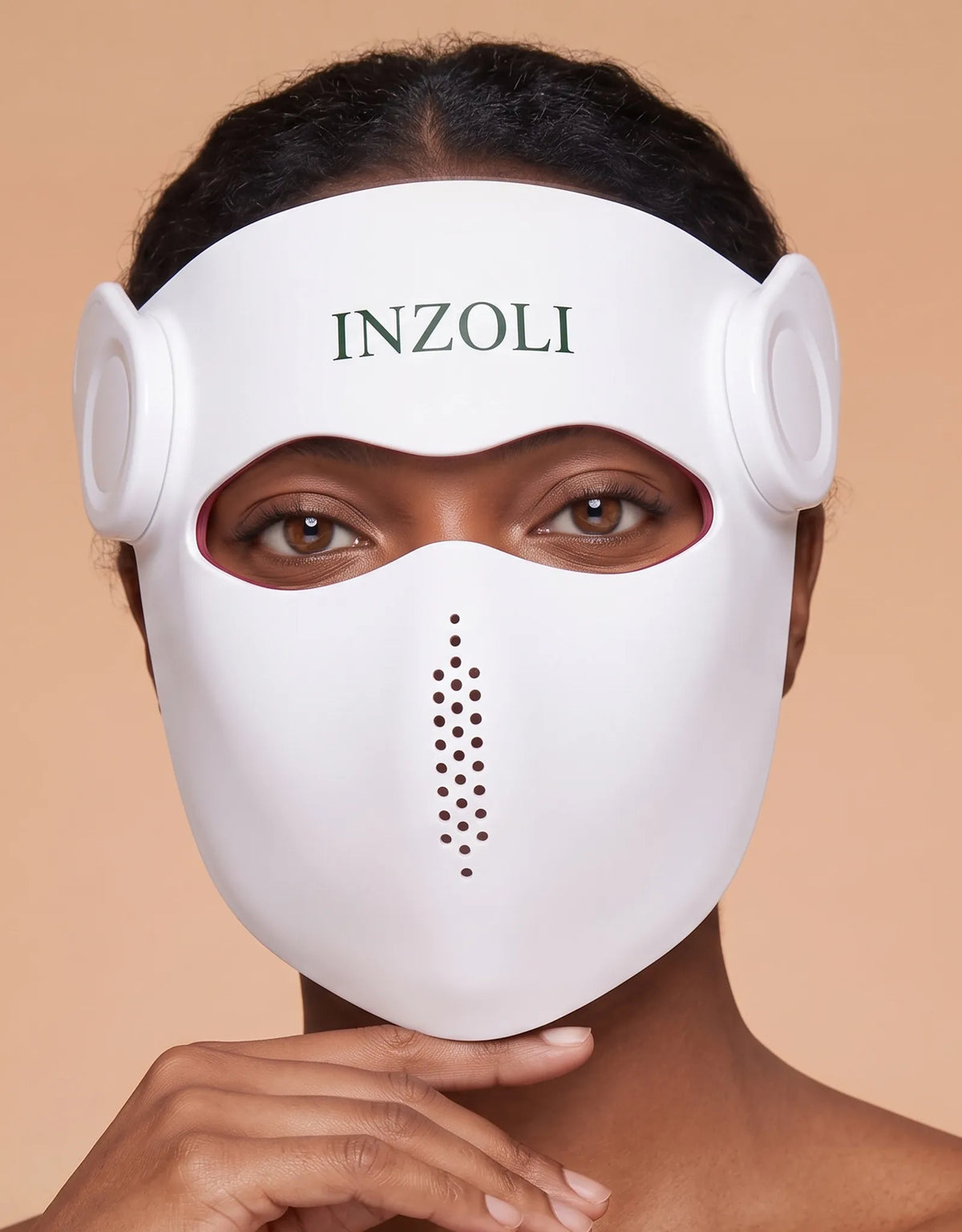 Woman wearing the Inzoli 4D laser face mask in a relaxed at-home setting